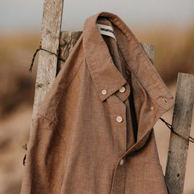 The Jack in Faded Brick Chambray hanging on a fence