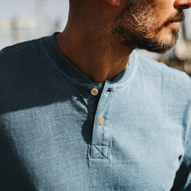 fit model showing off buttons on The Organic Cotton Henley in Washed Indigo