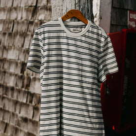 editorial image of The Organic Cotton Tee in Washed Indigo Stripe on a hanger