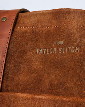 material shot of the branding on The Roughout Tote in Chocolate Suede, Accessories by Taylor Stitch