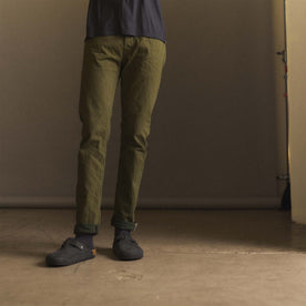 fit model showing off The Slim Jean in Olive Nihon Menpu Selvage