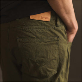 fit model showing back pocket on The Slim Jean in Olive Nihon Menpu Selvage