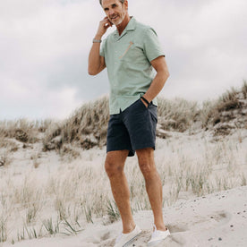 fit model walking on the beach wearing The Short Sleeve Hawthorne in Sea Moss Floral