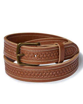 editorial image of The Tooled Belt in Saddle Tan rolled up, Accessories by Taylor Stitch