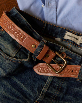 editorial image of The Tooled Belt in Saddle Tan on a pair of jeans, Accessories by Taylor Stitch