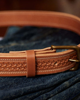 editorial image of The Tooled Belt in Saddle Tan clasped, Accessories by Taylor Stitch