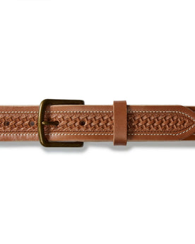 flatlay of the buckle on The Tooled Belt in Saddle Tan, Accessories by Taylor Stitch