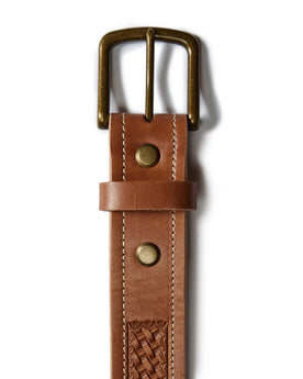 flatlay of the belt buckle The Tooled Belt in Saddle Tan, Accessories by Taylor Stitch