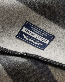 material shot of the tag on The Wool Blanket in Bay Stripe, Accessories by Taylor Stitch