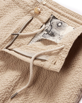 material shot of the zipper fly and drawcords on The Easy Pant in Heather Oat Seersucker, Bottoms by Taylor Stitch