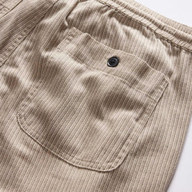 material shot of the back pocket on The Apres Short in Black Coffee Stripe