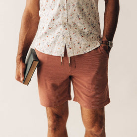 fit model with his hand in his pocket wearing The Apres Short in Fired Brick Dobby