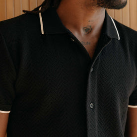 fit model showing off the collar on The Button Down Polo in Coal Herringbone