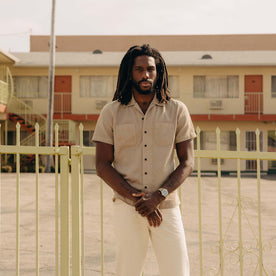 fit model with his arms crossed wearing The Conrad Shirt in Black Coffee Stripe