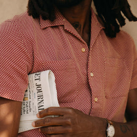 fit model showing off the pockets on The Conrad Shirt in Fired Brick Dobby
