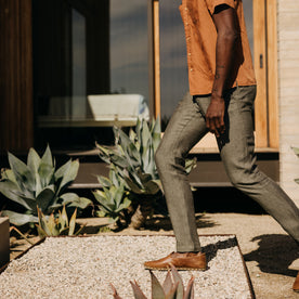 fit model walking on gravel wearing The Easy Pant in Olive Linen