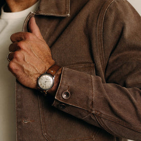 fit model adjusting The Fremont Jacket in Aged Penny Chipped Canvas