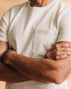 fit model with his arms crossed wearing The Heavy Bag Tee in Natural, Knits by Taylor Stitch