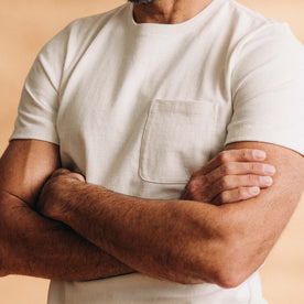 fit model with his arms crossed wearing The Heavy Bag Tee in Natural