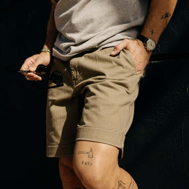 fit model with his hand in his pocket wearing The Matlow Short in Baked Soil Herringbone