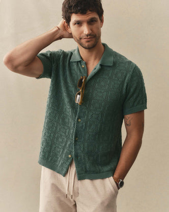 fit model posing in The Monterey Sweater Polo in Deep Sea Geo Crochet