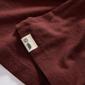 material shot of the hem with TS label on The Cotton Hemp Tee in Black Cherry