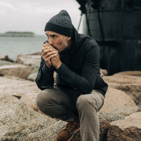 fit model by a lighthouse in The Headland Beanie in Dark Navy