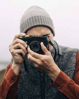fit model taking a photo in The Headland Beanie in Warm Grey, Accessories by Taylor Stitch