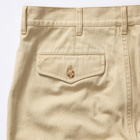 material shot of the back pocket on The Matlow Pant in Light Khaki Pigment Herringbone