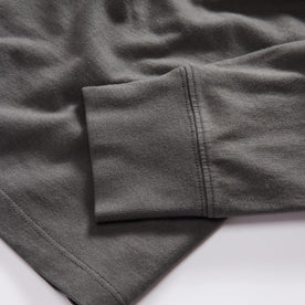 material shot of the sleeve on The Organic Cotton Henley in Faded Black