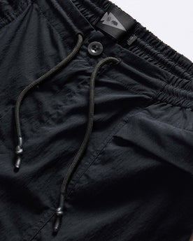 material shot of the drawstring on The Challenge Cargo Short in Black, Bottoms by Taylor Stitch