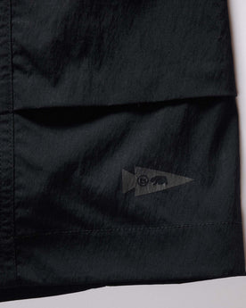 material shot of the tag on The Challenge Cargo Short in Black, Bottoms by Taylor Stitch