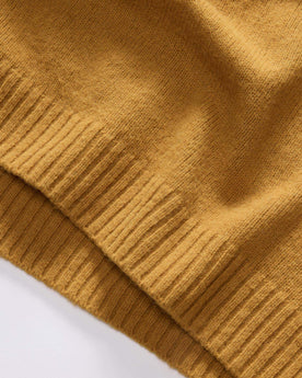 material shot of the ribbed hem on The Lodge Sweater in Gold, Knits by Taylor Stitch