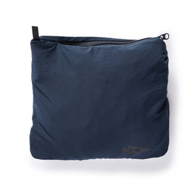 material shot of the small bag that holds The Deploy Packable Shell in Dark Navy
