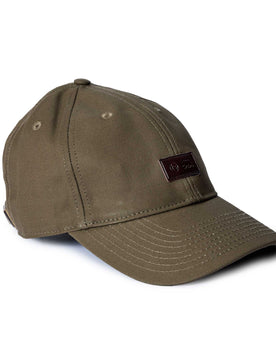 editorial image of the side of The Pathfinder Cap in Fatique Olive Dry Wax, Accessories by Taylor Stitch