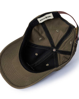 editorial image of the inside of The Pathfinder Cap in Fatique Olive Dry Wax, Accessories by Taylor Stitch