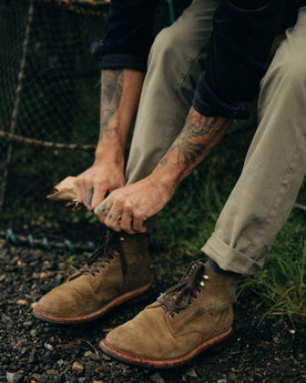 fit model adjusting the cuffs on The Slim Foundation Pant in Organic Smoked Olive, Bottoms by Taylor Stitch