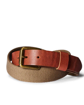 editorial image of The Webbed Belt in Whiskey rolled up, Accessories by Taylor Stitch