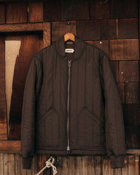 editorial image of The Able Jacket in Soil Quilted Nylon on a hanger, Outerwear by Taylor Stitch
