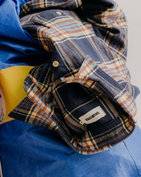editorial image of The Ledge Shirt in River Plaid on a bag, Wovens by Taylor Stitch