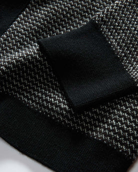 material shot of the sleeves on The Nichols Polo in Black Birdseye Merino, Knits by Taylor Stitch