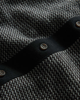 material shot of the buttons on The Nichols Polo in Black Birdseye Merino, Knits by Taylor Stitch