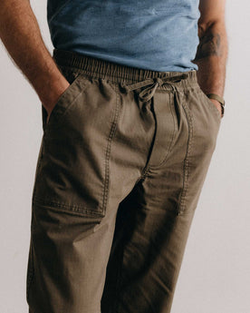 fit model showing off the pockets on The Breakwater Pant in Mushroom Ripstop, Bottoms by Taylor Stitch