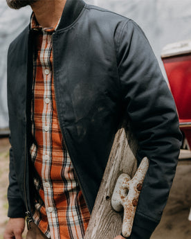 fit model posing in The Insulated Bomber Jacket in Dark Navy Dry Wax, Outerwear by Taylor Stitch