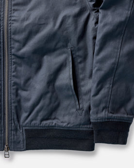 material shot of the pockets on The Insulated Bomber Jacket in Dark Navy Dry Wax, Outerwear by Taylor Stitch