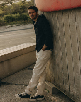 fit model leaning against the wall wearing The Apres Zip Hoodie in Rinsed Indigo Terry, Knits by Taylor Stitch