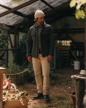 fit model adjusting the sleeves on The Shop Shirt in Navy Chipped Canvas, Wovens by Taylor Stitch