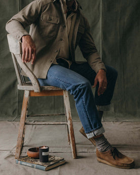 fit model sitting in The Straight Jean in Mid Wash Organic Selvedge, Bottoms by Taylor Stitch