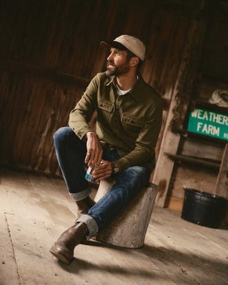 fit model sitting wearing The Ledge Shirt in Bay Leaf Twill