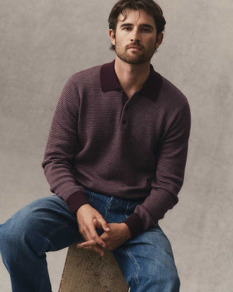 fit model sitting wearing The Newton Sweater Polo in Burgundy Birdseye Merino